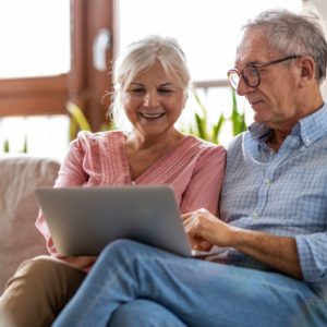 Mature couple using a laptop to research tips for living with diabetes.