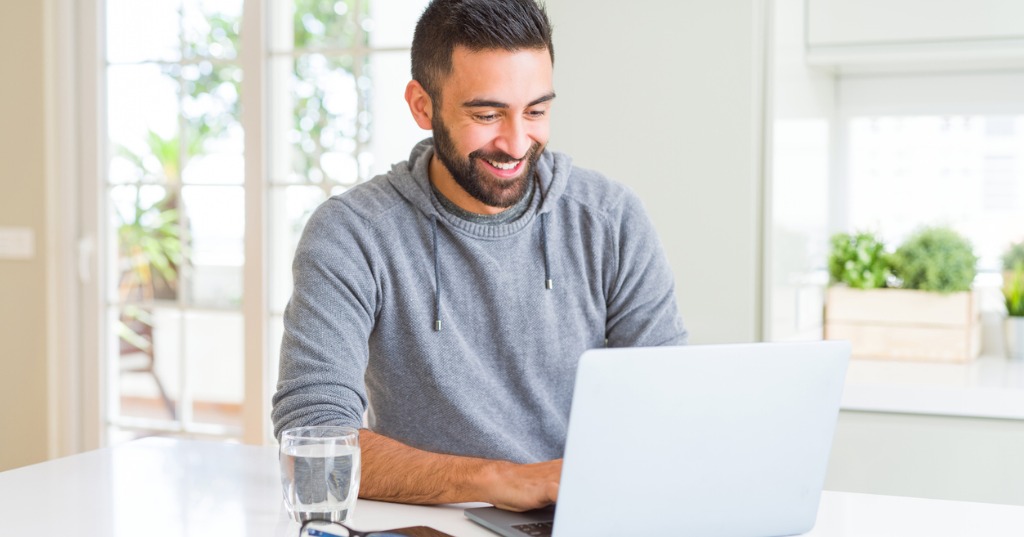 Man Smiling Working Using Computer Laptop Picture Id1167772588