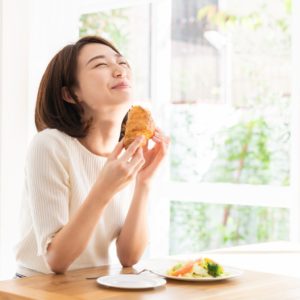 Attractive Asian Woman Eating gluten.