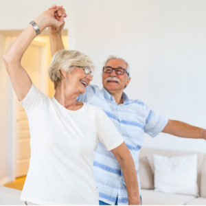 Carefree Happy Active Old Senior Couple Dancing after rekindling a spark with PRP Therapy.