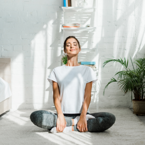 Young woman in a meditative yoga pose, experiencing a mindful morning.