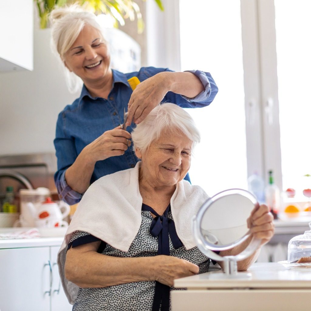 Woman Cutting Her Elderly Mothers Hair At Home Picture Id1248740159