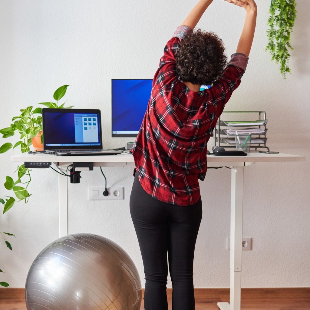 Woman Telecommuting At An Adjustable Standing Desk Picture Id1322162198