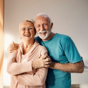 Happy Senior Couple Hugging after getting their hormones tested in Oregon.